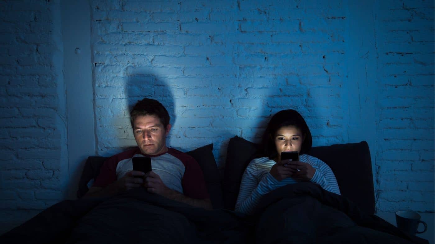 couple in the dark on cell phones communicating
