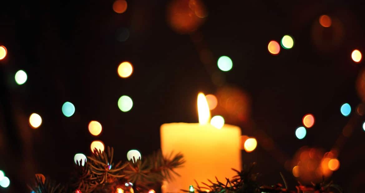 holiday candle lit in dark
