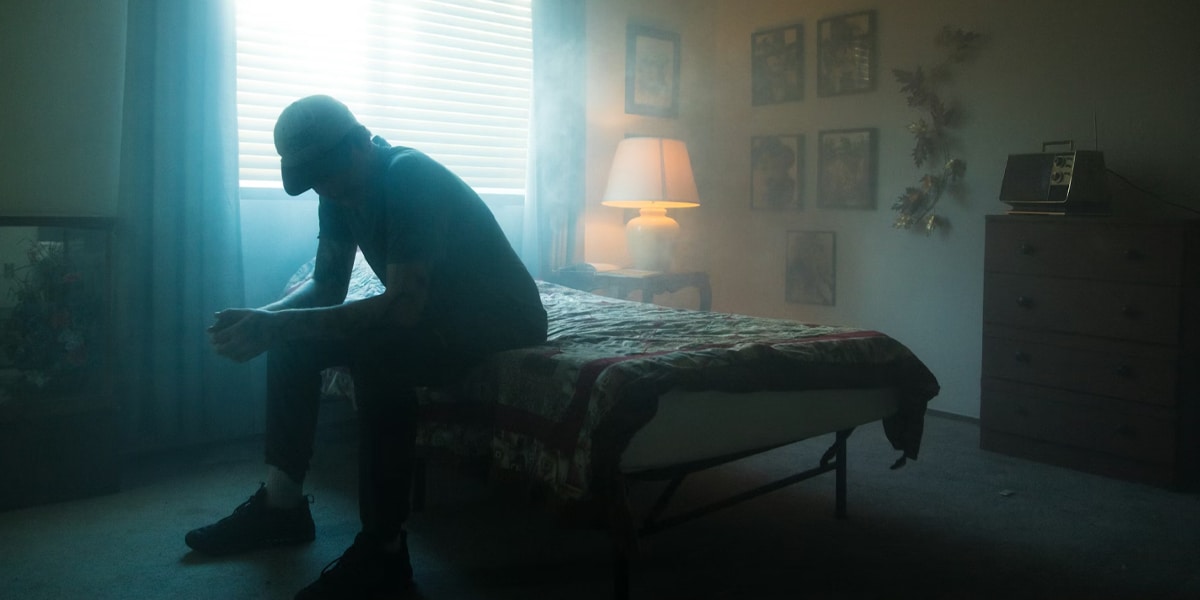 man sitting alone reflecting on mental health challenges in Calgary